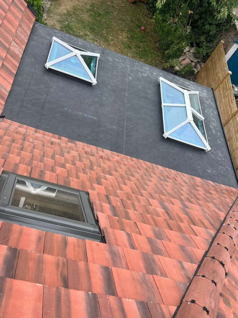 This is a photo taken from the roof ridge looking down a tiled pitched roof on to a flat roof. Works carried out by TRP Roofing Market Weighton