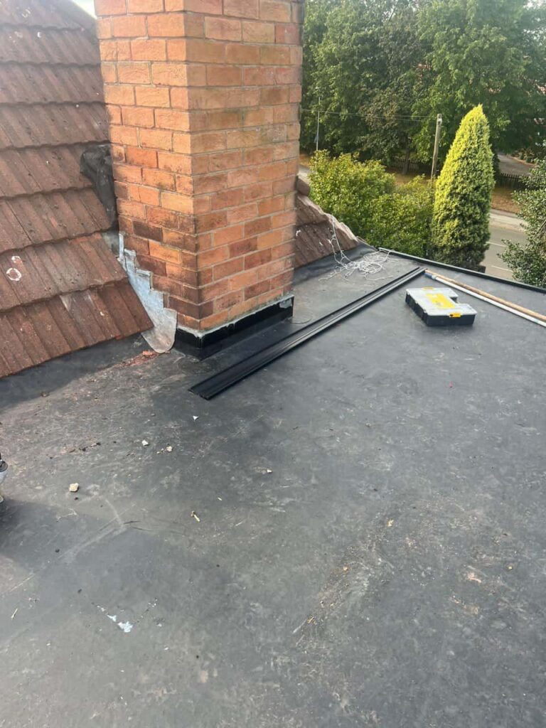 This is a photo of a flat roof which has just been repaired, there is also a chimney stack and some leadwork has also been dressed. Works carried out by TRP Roofing Market Weighton